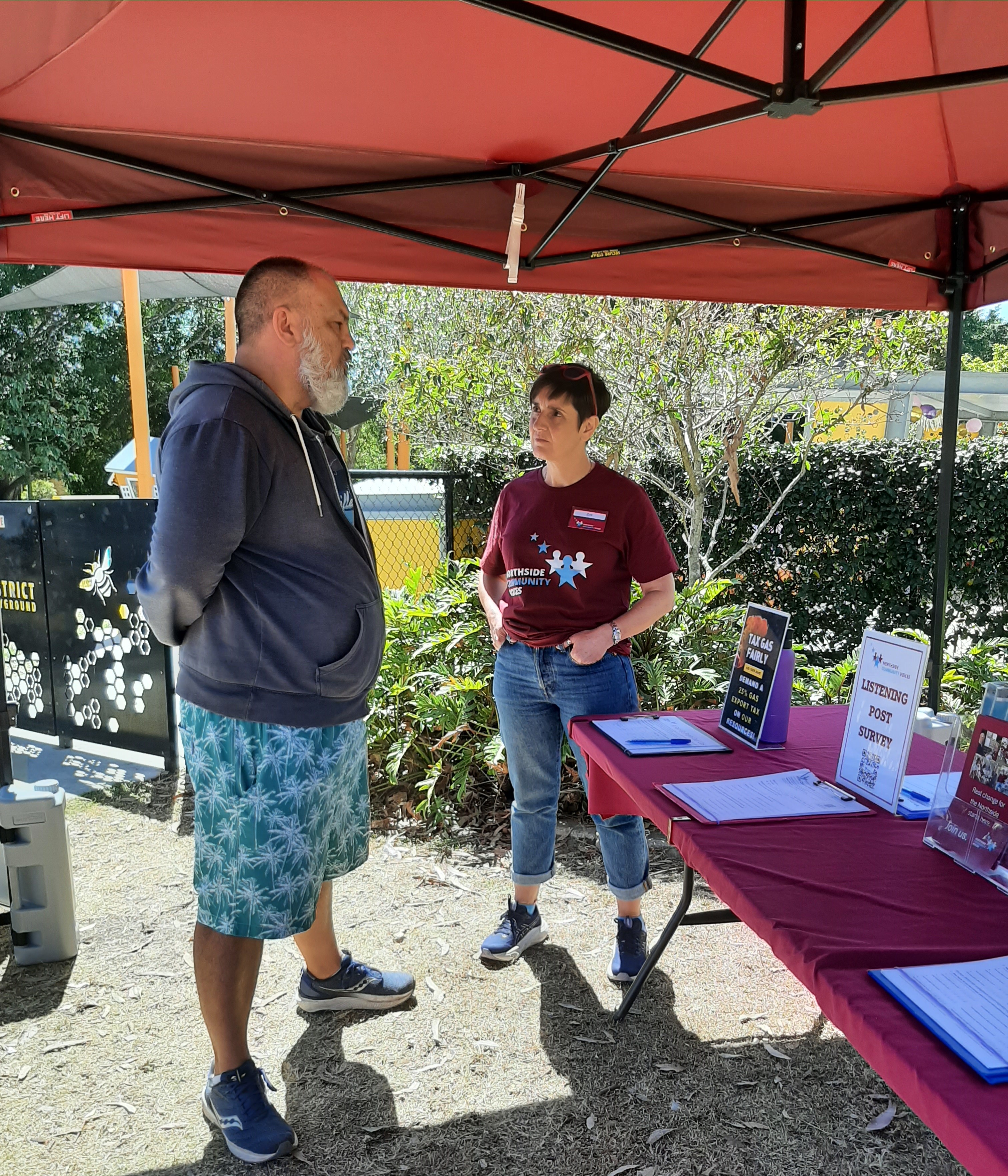 Residents filling in NCV listening forms at a table at Leslie Patrick Park, Arana Hills